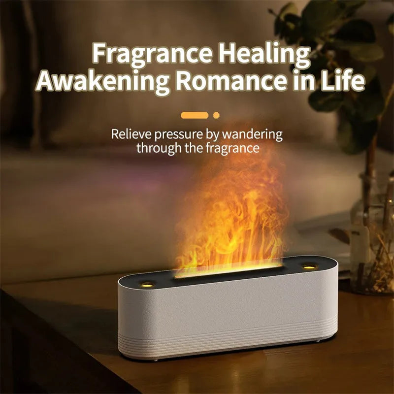 Tall black ultrasonic aroma diffuser with coloured flame LED light and rising water mist on a desk.