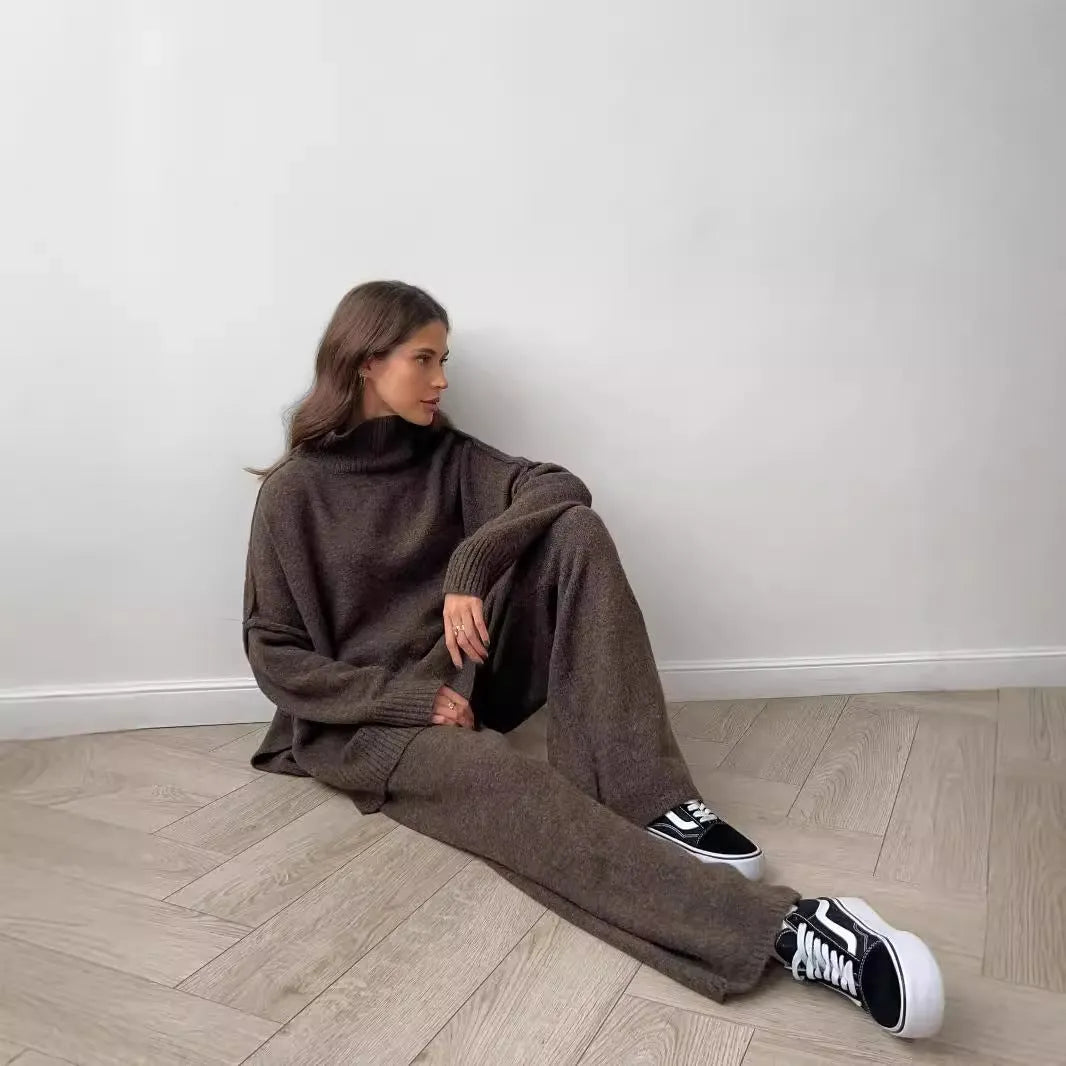 Women's acrylic knit sweater suit with side-slit top and matching trousers in dark grey