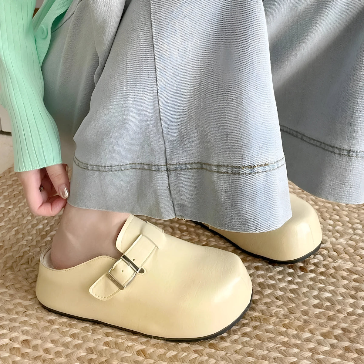 Flat buckle casual sneakers in yellow, creamy-white, silver, and black colours showing round toe and buckle detail.