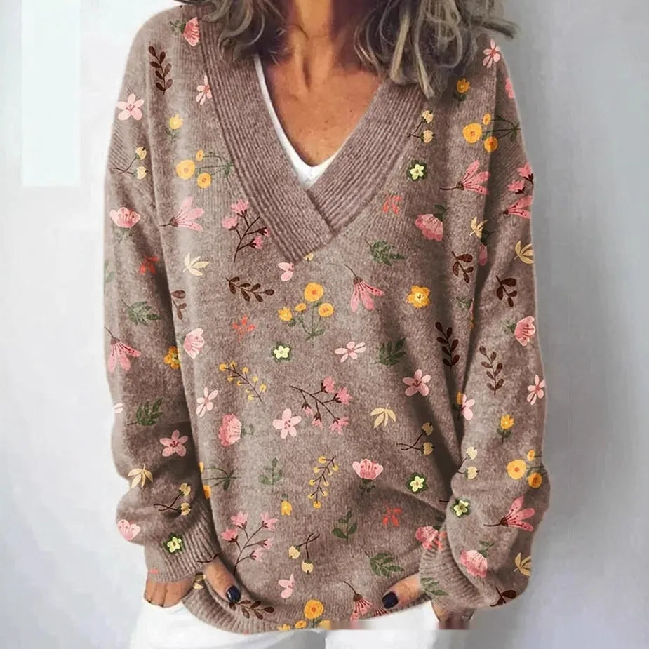 Women's grey V-neck sweatshirt with a white 3D floral pattern print and long sleeves.