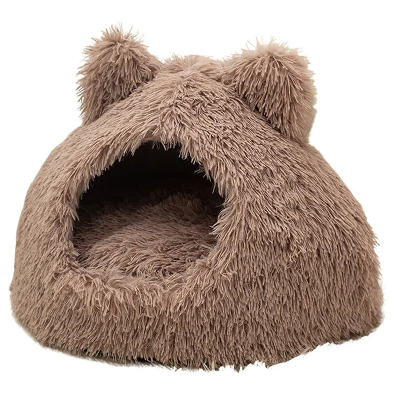 Large semi-closed flannel cat nest in dark gray on a floor, with soft plush interior visible