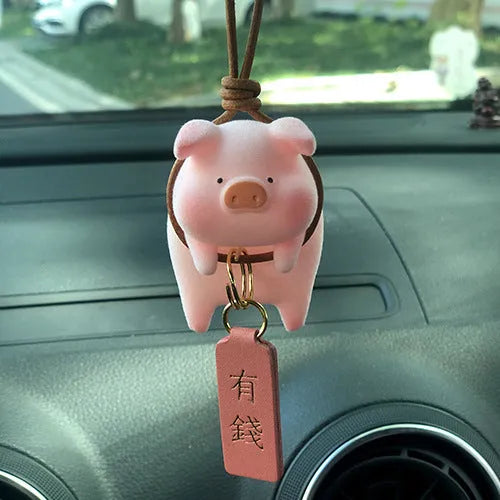 A cute resin cartoon pig figurine car dashboard decoration on a grey background.