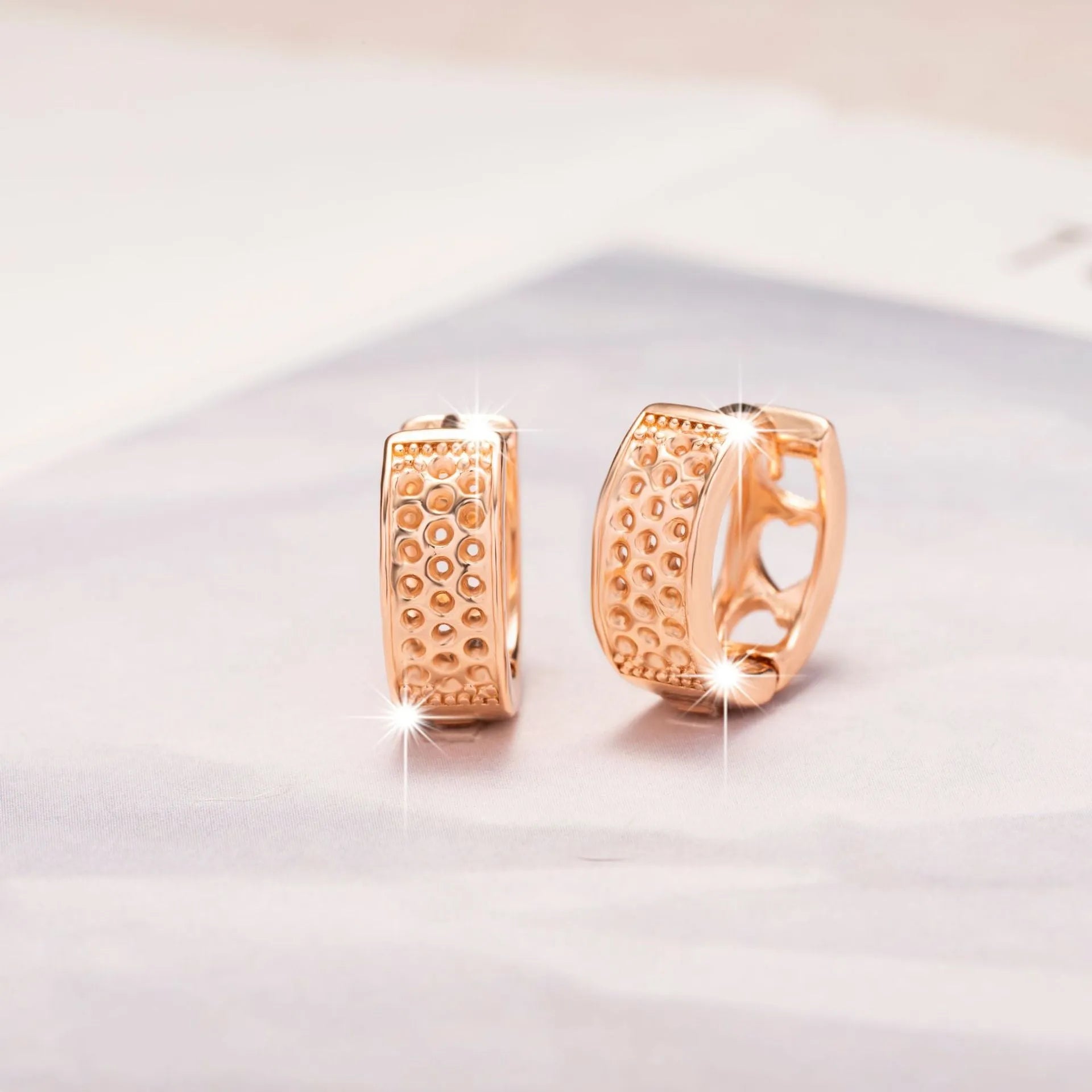 Rose gold electroplated women's earrings with hollowed-out heart design inside circular frame