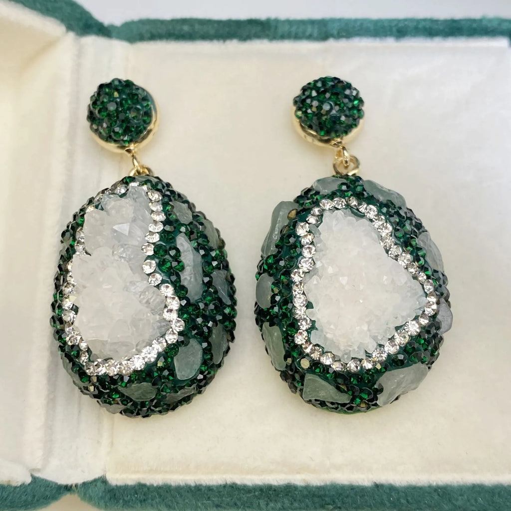 Crystal Bud Inlaid Emerald Earrings in dark green with a copper geometric base and crystal bud detail on a white background