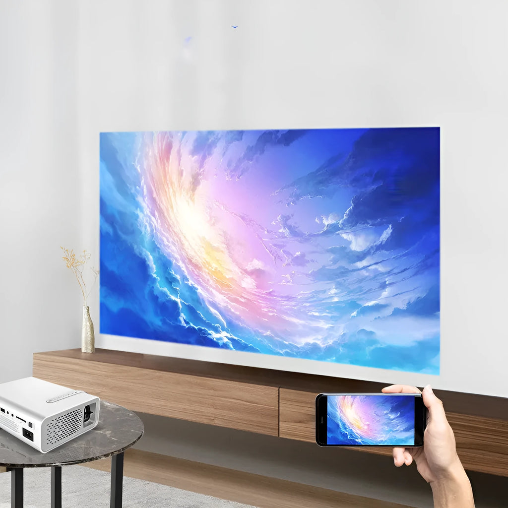 Black YG530 mini wireless mobile phone LED projector on a table, showing a large projected image.