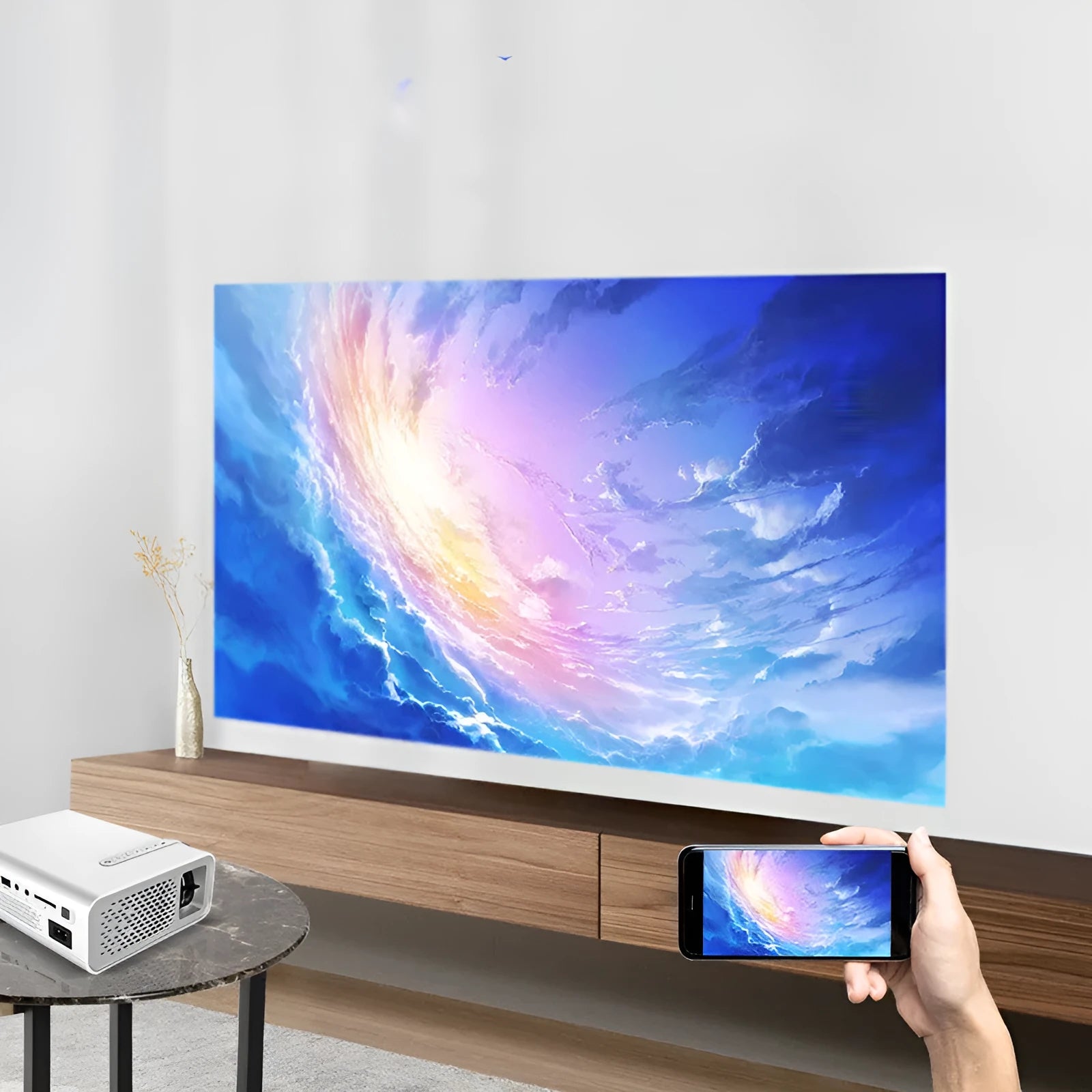Black YG530 mini wireless mobile phone LED projector on a table, showing a large projected image.