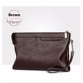 Men's PU leather clutch bag in black with wrist strap, soft carry handle, and zipper compartments