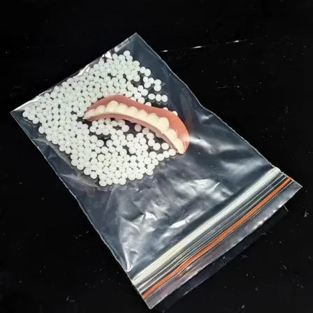 Disposable silicone simulation smile dentures with upper and lower teeth in colour box packaging