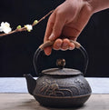 Cast iron teapot with traditional Japanese-style pattern and 0.9 litre capacity