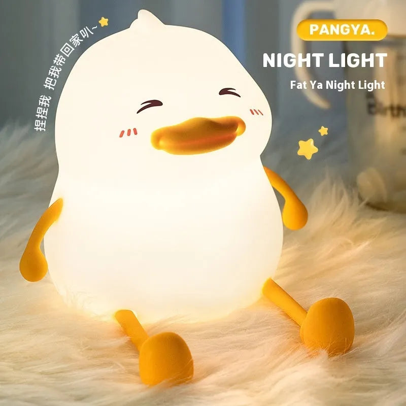Chubby silicone night light with LED glow functioning as a desktop phone holder