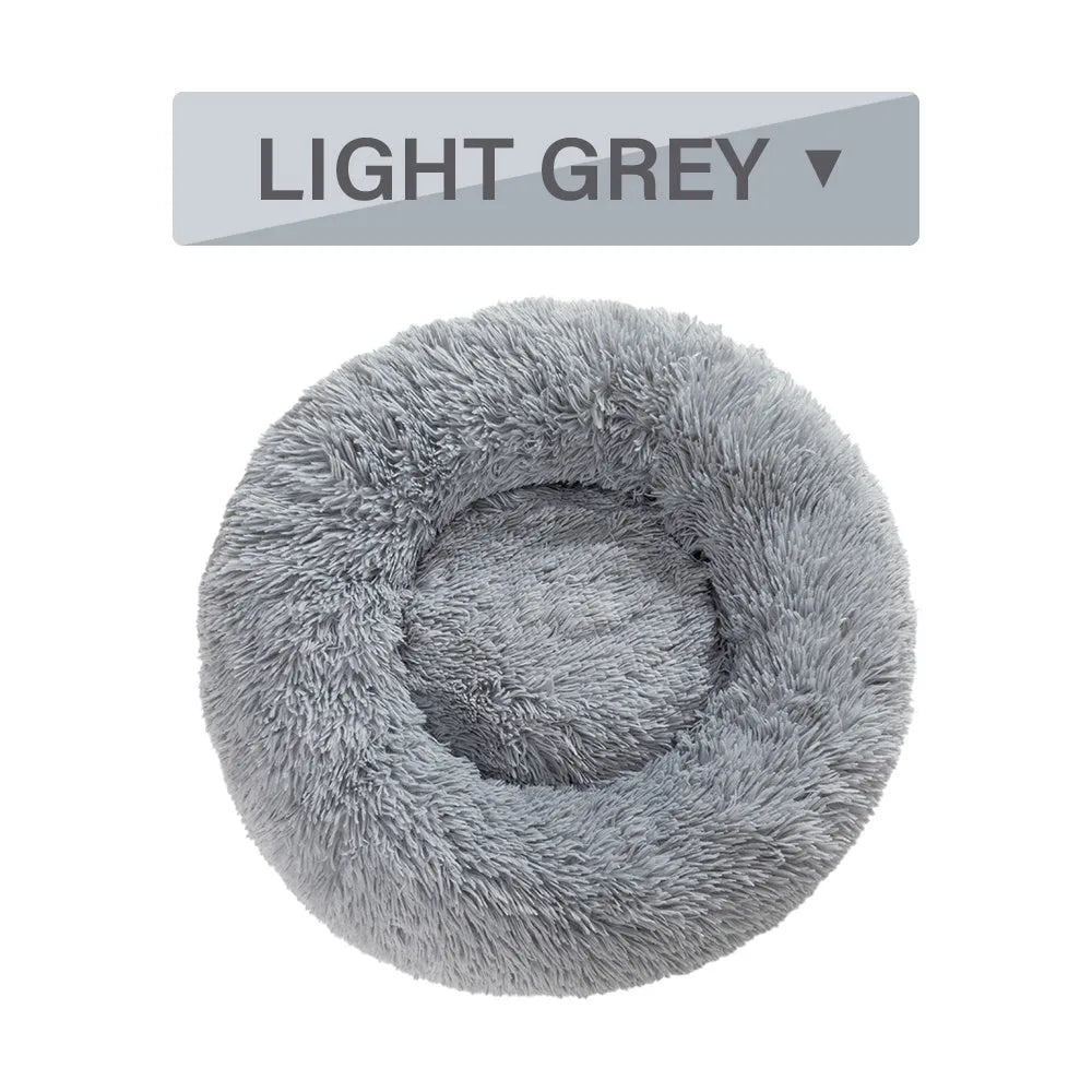 Fluffy donut-shaped pet bed in long plush fabric, shown in a grey colour