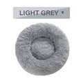 Fluffy donut-shaped pet bed in long plush fabric, shown in a grey colour