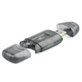 Transparent plastic USB card reader with LED illumination on a desk.