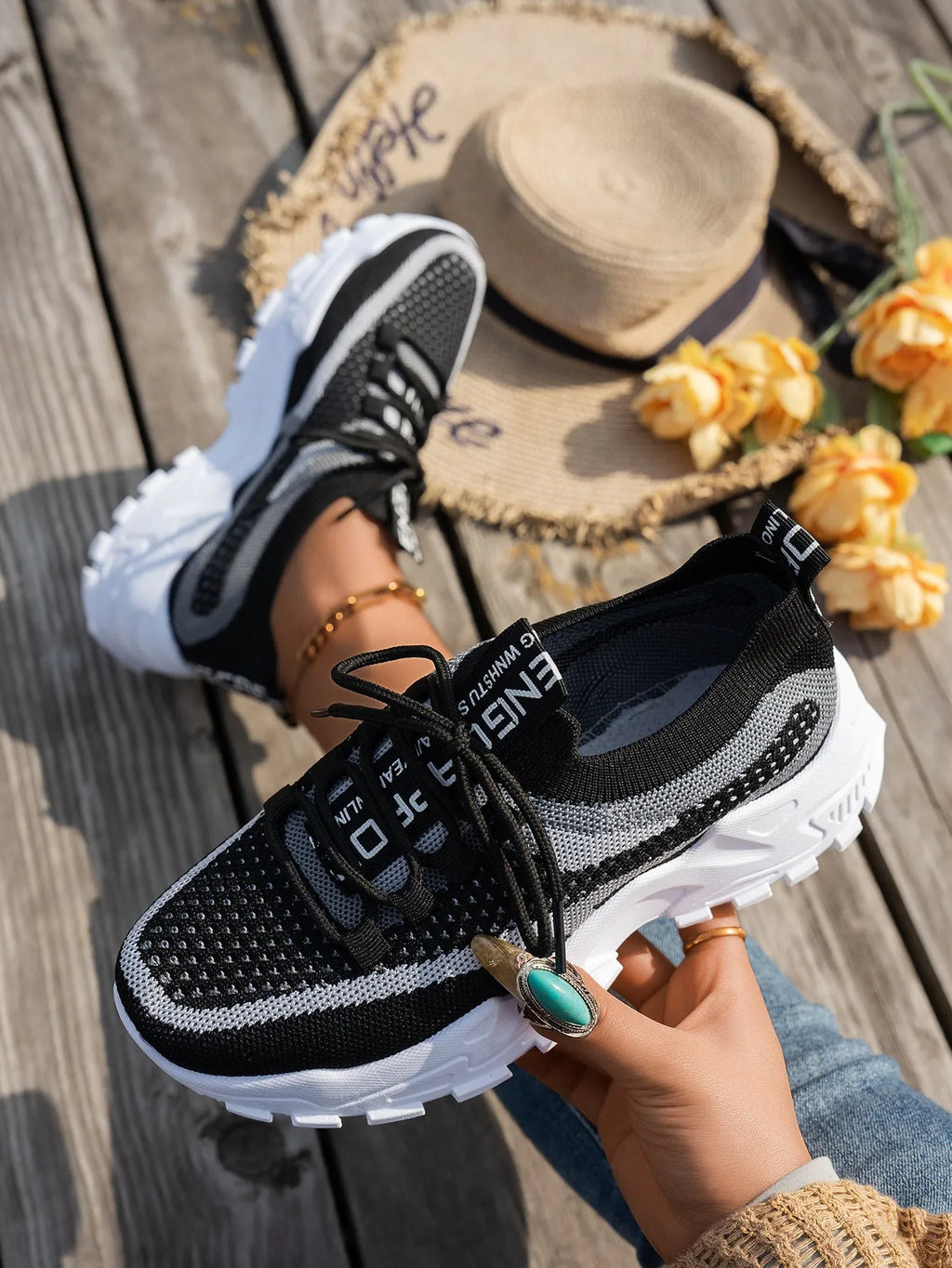 Women's Flyknit mesh lace-up sneakers in a colour option, showing the round toe and rubber sole.