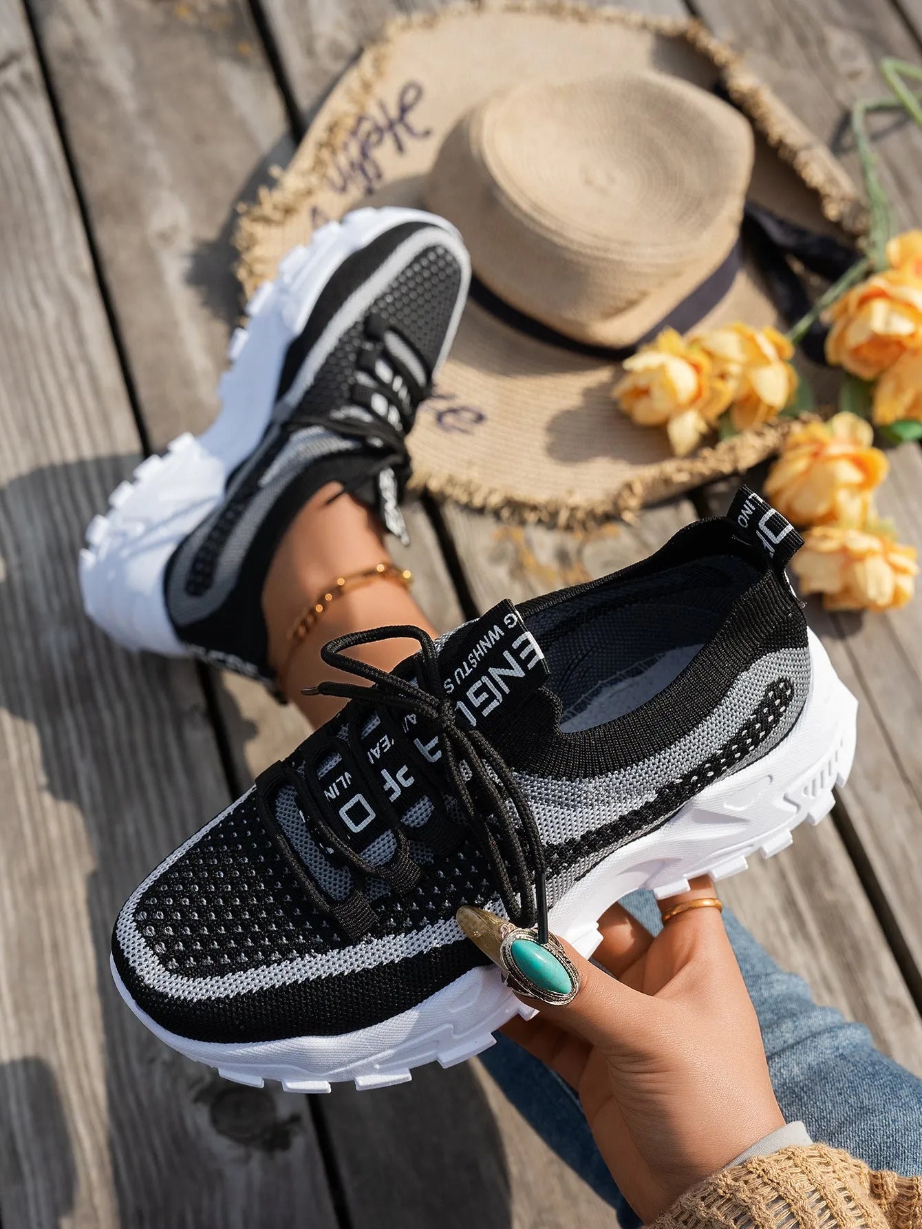 Women's Flyknit mesh lace-up sneakers in a colour option, showing the round toe and rubber sole.