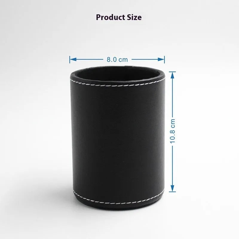 Small round black leather pen container on desk with pens inside