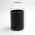 Small round black leather pen container on desk with pens inside