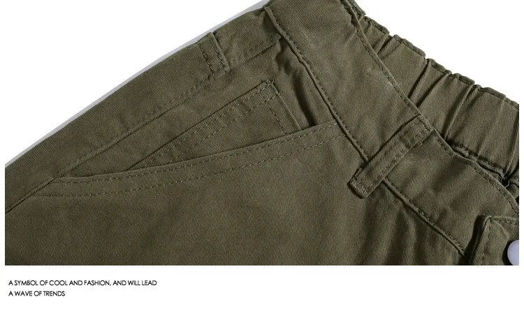 Workwear-style cropped pants with wide-leg design in apricot colour showing mid waist and loose fit