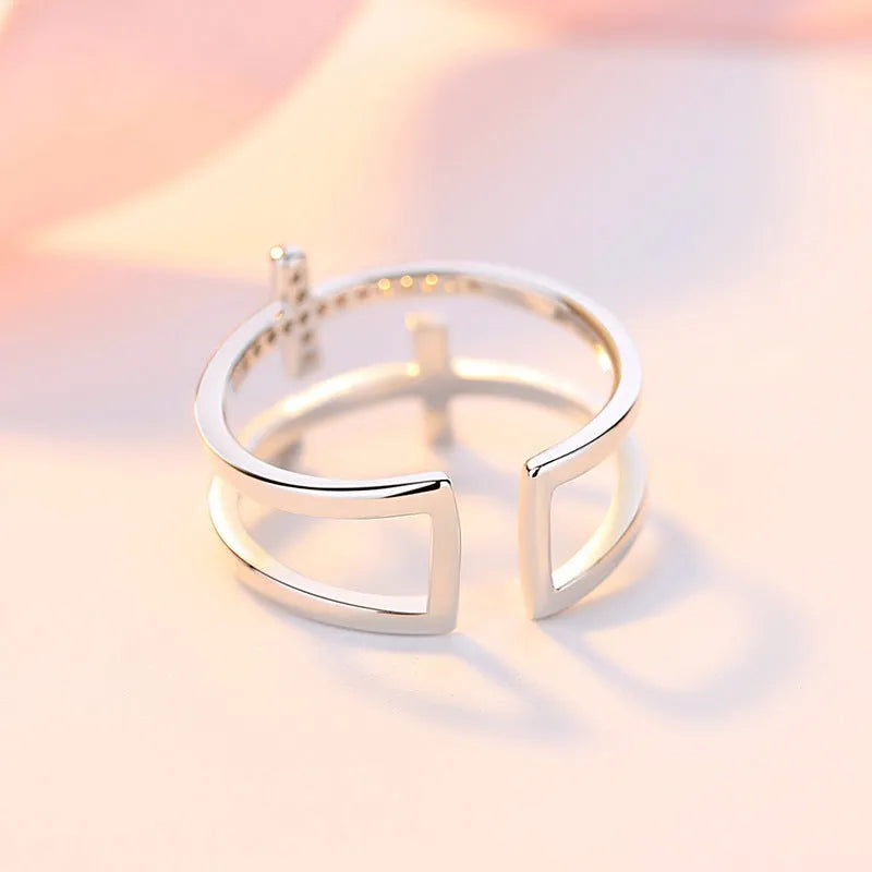 Adjustable copper women's ring with double cross design, zircon stones, and sterling silver inlay in white gold finish.