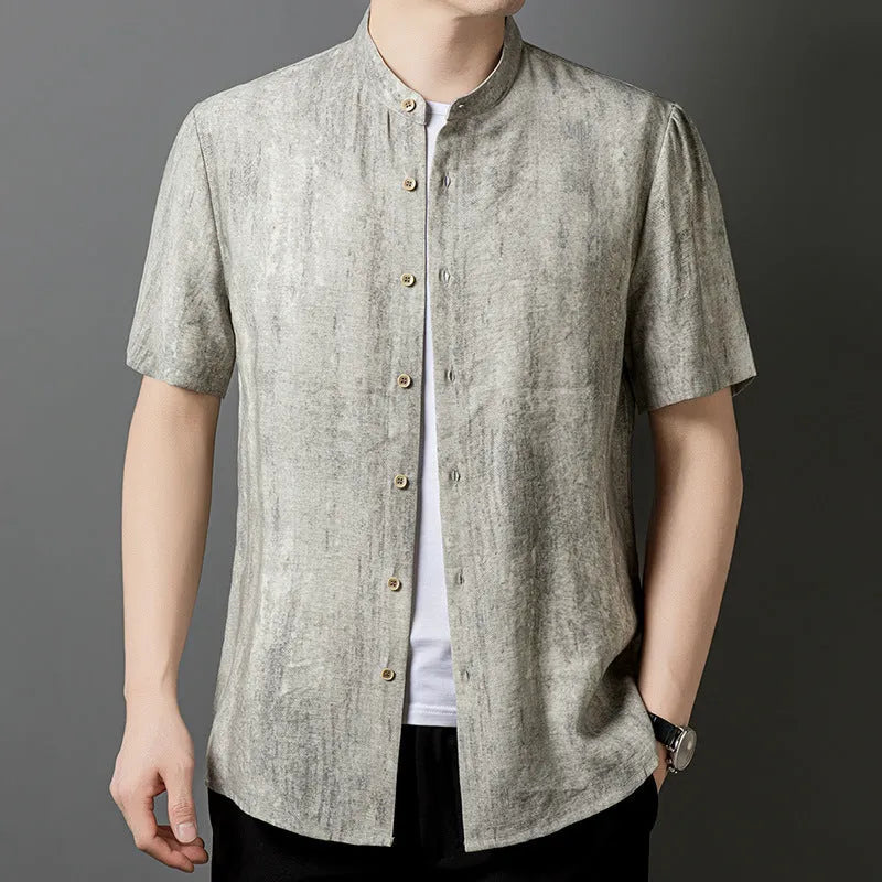 Man wearing a loose-fit black grey linen blend cardigan shirt with a stand collar.