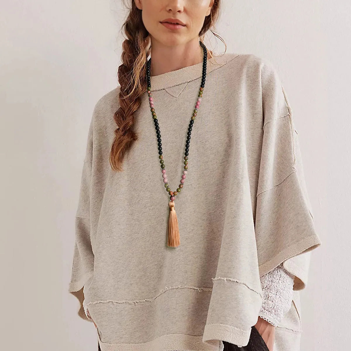 Long 108-bead natural stone necklace with colour-matched tassels and a geometric gem-inlaid pendant on a ball bead chain.