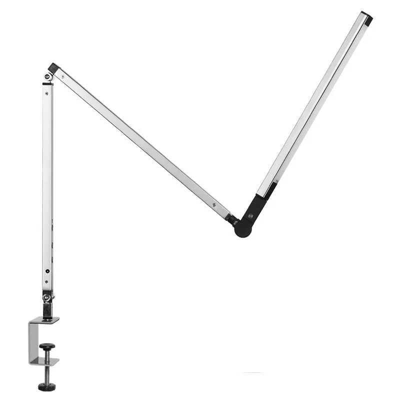 Clip-on aluminium desk lamp with remote control in dazzling black colour, mounted on a desk edge.