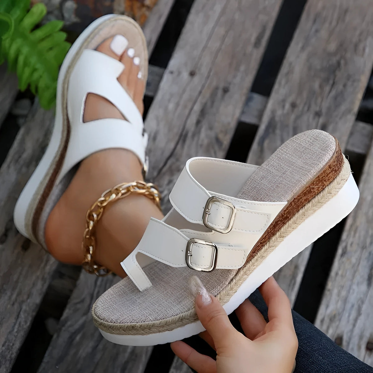 White woven patent leather women's wedge sandals with peep toe and finger-fit design on a neutral background.