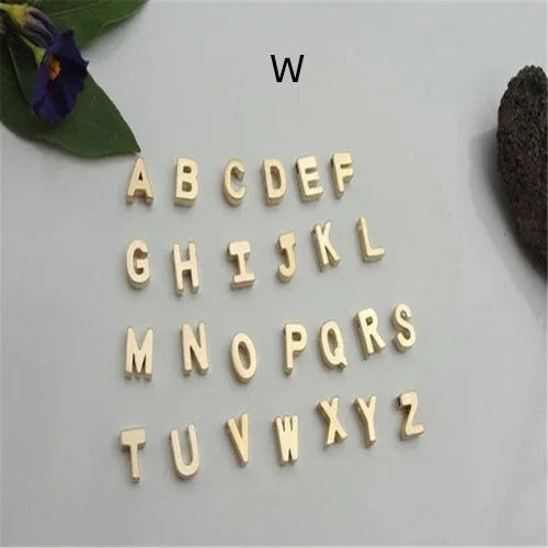 Gold heart shaped alloy pendant with initial letter on white background