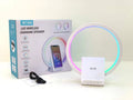 White portable Bluetooth speaker with integrated wireless charging pad and ambient lighting.