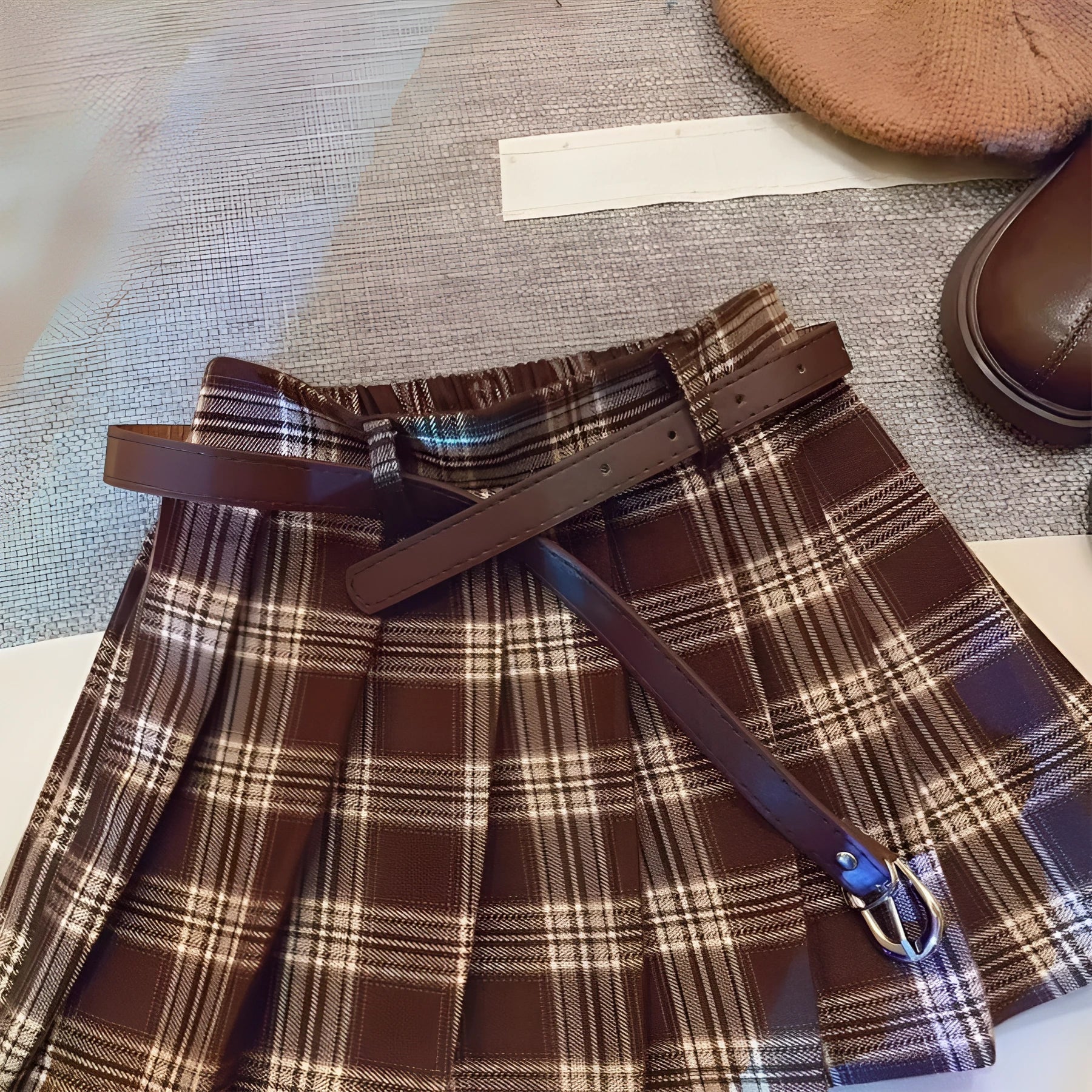 Girls' cotton plaid pleated skirt in A-line style showing pleat detail and plaid pattern