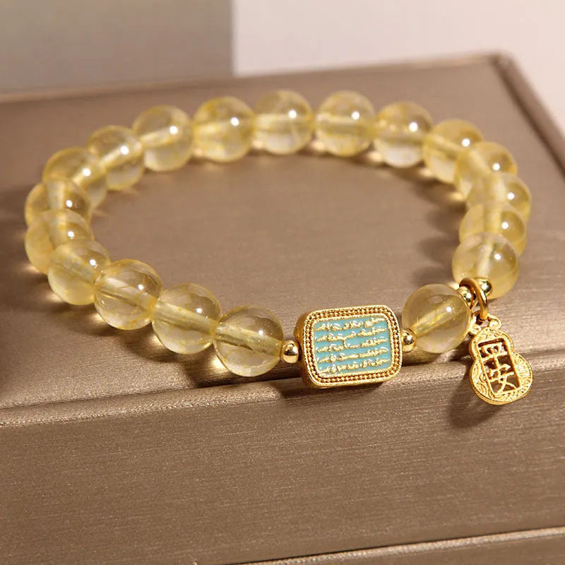 Women's yellow citrine crystal bracelet with rhinestone accents on wrist