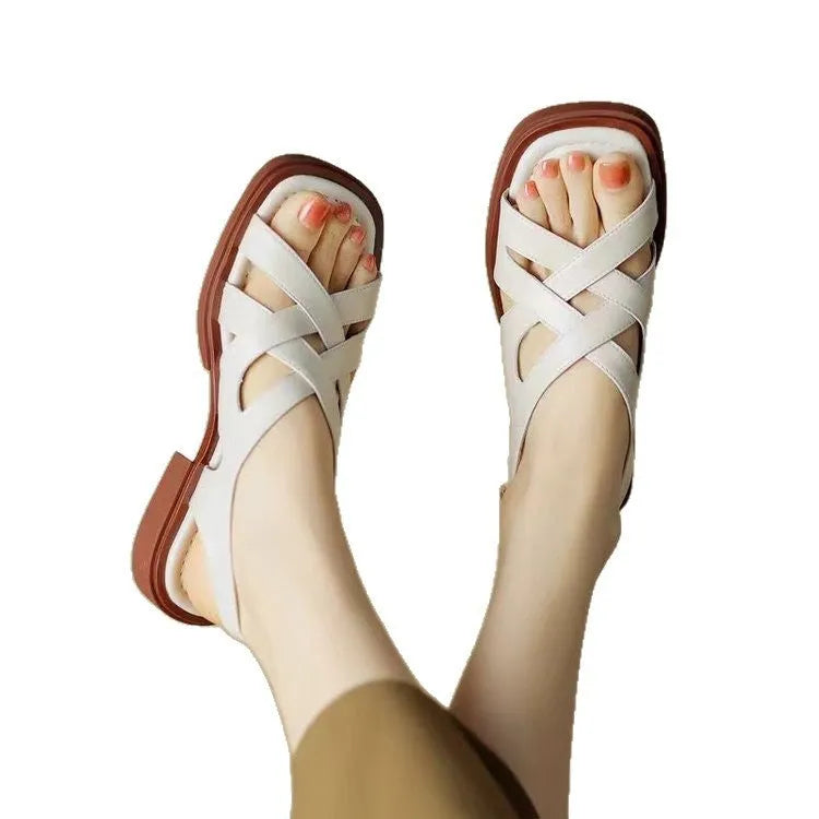 Women's patent leather low heel square toe beach sandals in black colour with cross strap design