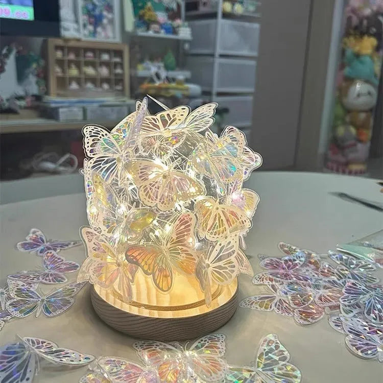 Butterfly-shaped night lamp with glass shade on raw wood base, measuring 12x15cm