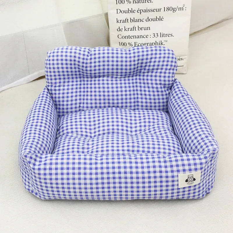 Car-mounted pet travel nest in grey and blue plaid colours showing stain-resistant cloth construction