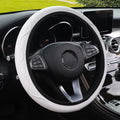 Embossed corrugated elastic steering wheel cover in black, shown fitted on a car steering wheel.