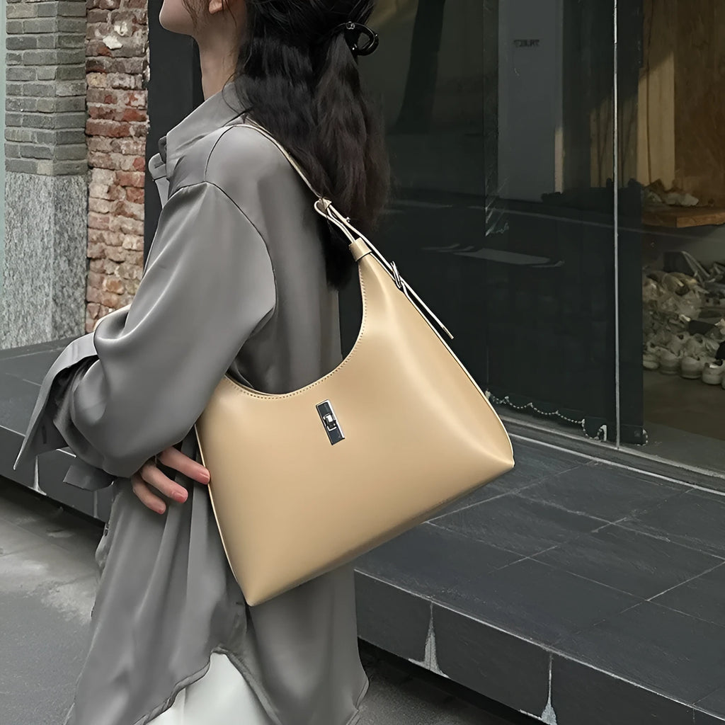Soft genuine leather crossbody shoulder bag in dumpling shape with internal phone pocket and change compartment