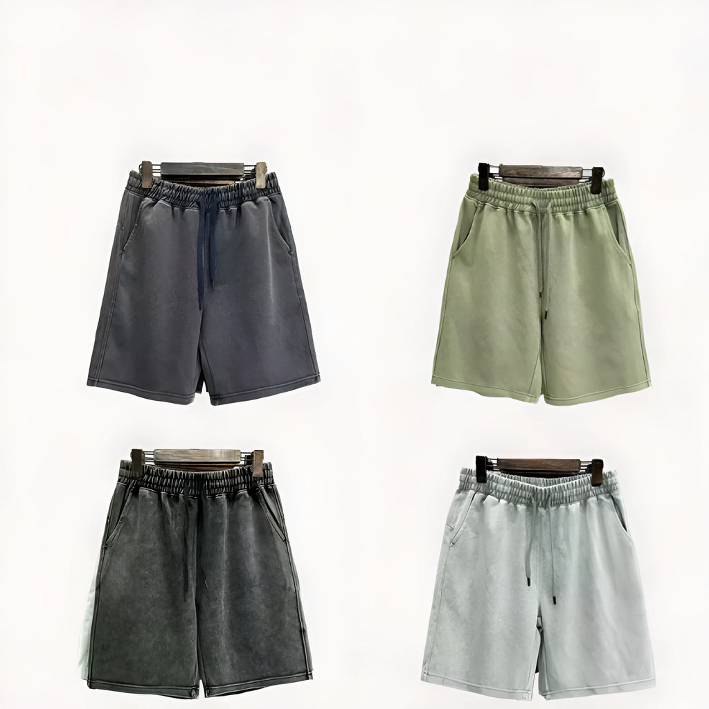 Men's cotton distressed casual shorts in loose straight-leg fit, shown in one of four solid colours.