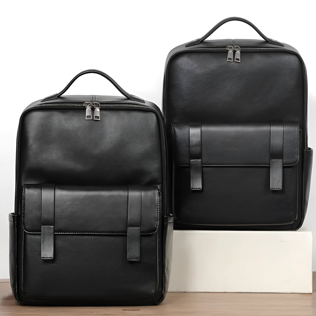 Men's black genuine leather computer backpack with curved back plate showing litchi grain texture and substantial 36-55L capacity.