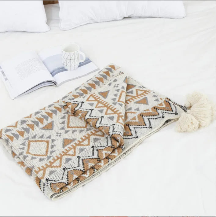 Bohemian-style acrylic sofa cover blanket with tassel trim in a geometric pattern colour option
