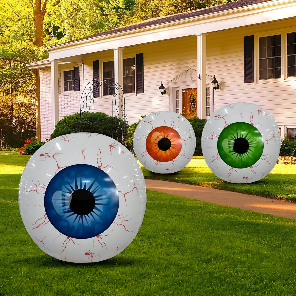 Large inflatable Halloween eyeball balloon with red bloodshot design on a white background