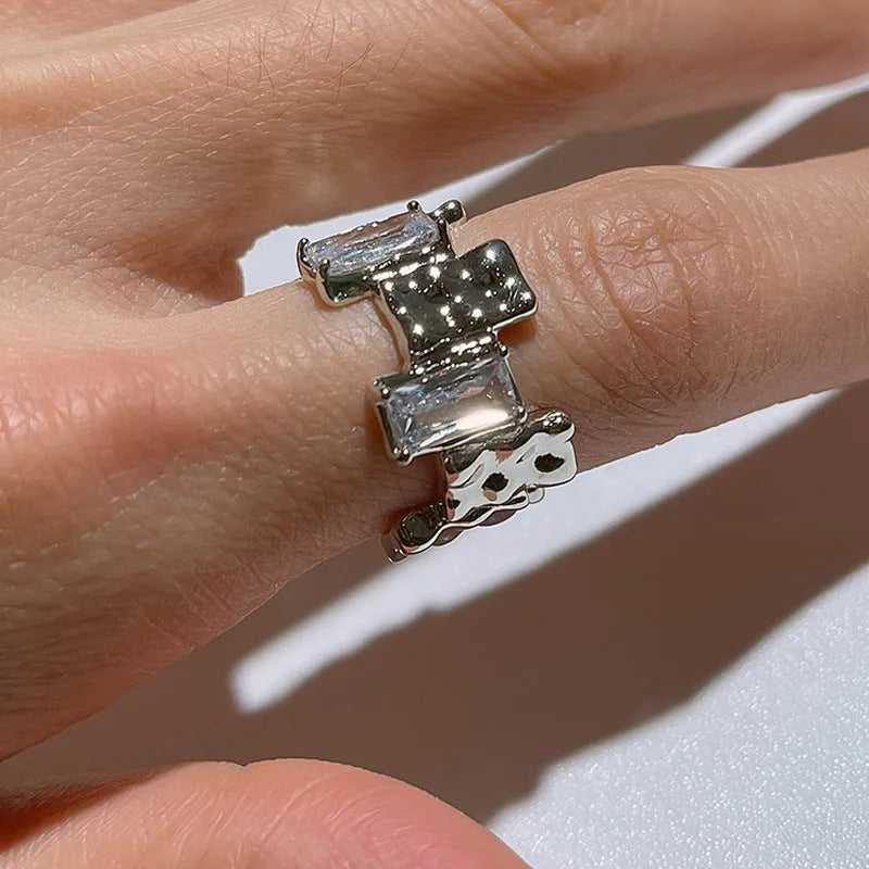 Silver plated open ring with geometric cross zircon and retro design.