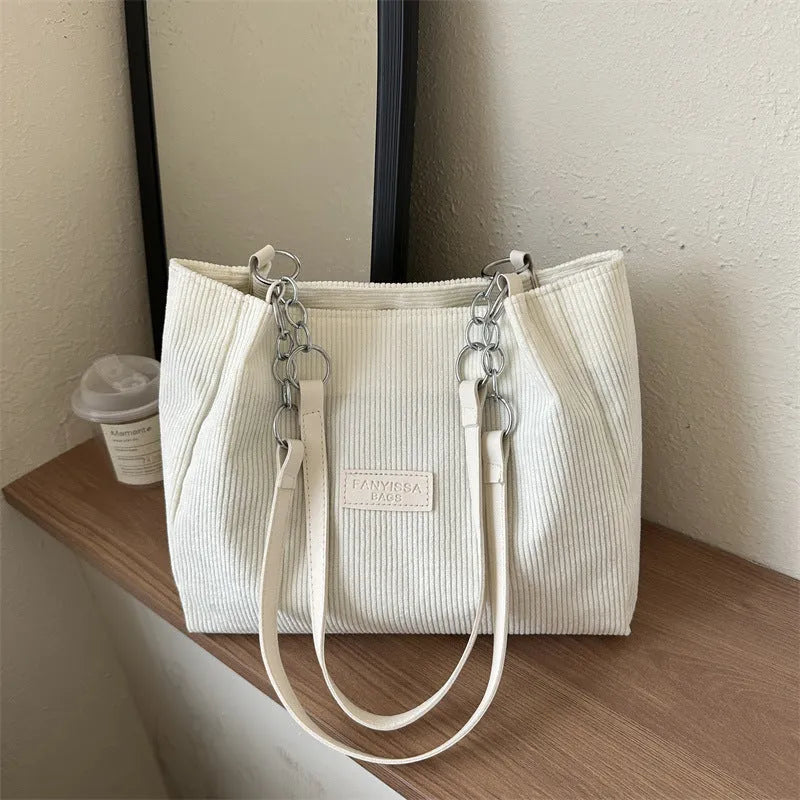 Corduroy one-shoulder tote bag with three-dimensional front pocket in street style design