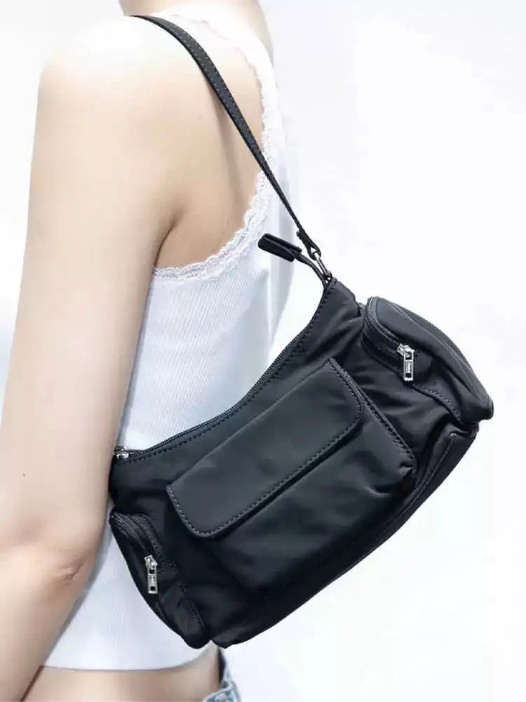 Black nylon lightweight double pocket women's shoulder bag showing side line detail