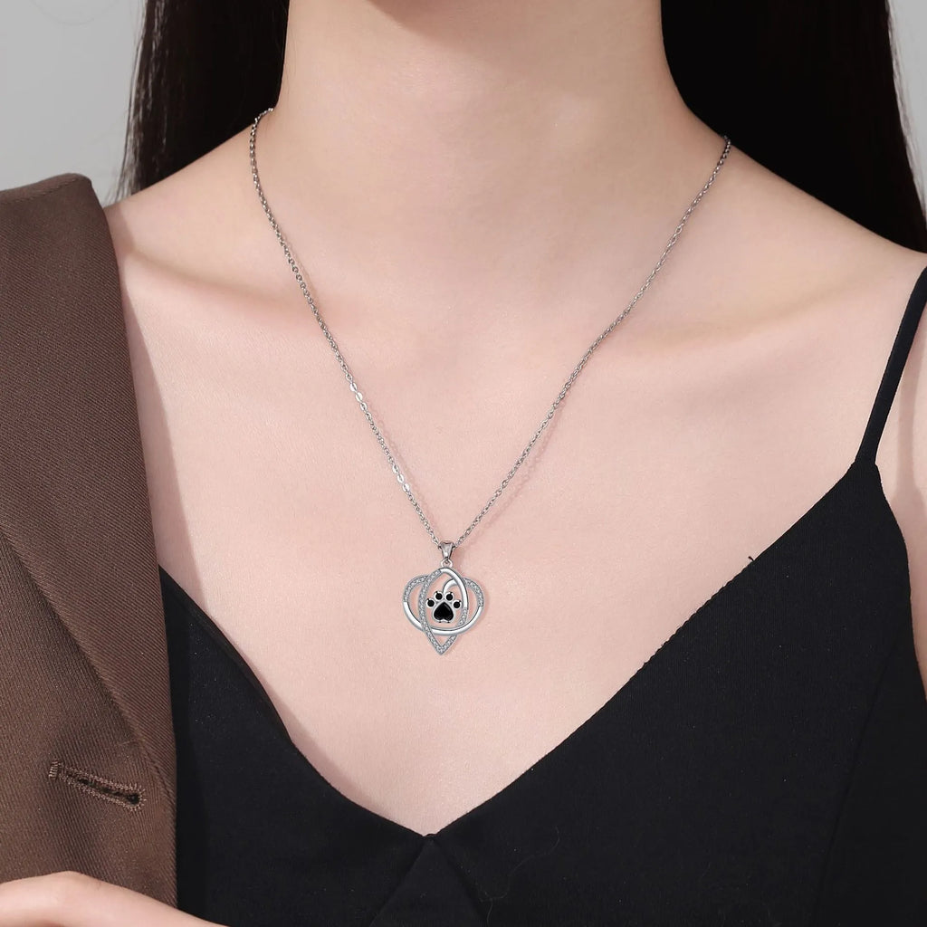Copper necklace with cat and dog paw prints pendant on a cross chain, electroplated finish.