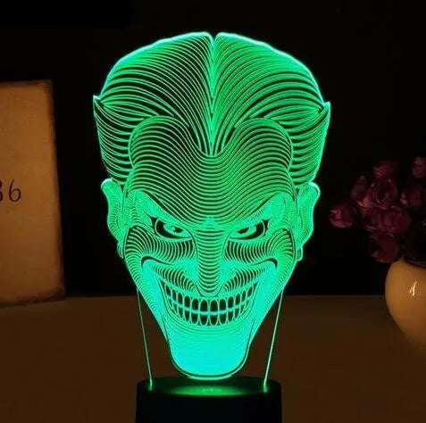 3D acrylic LED table lamp with USB cable and remote control on a desk