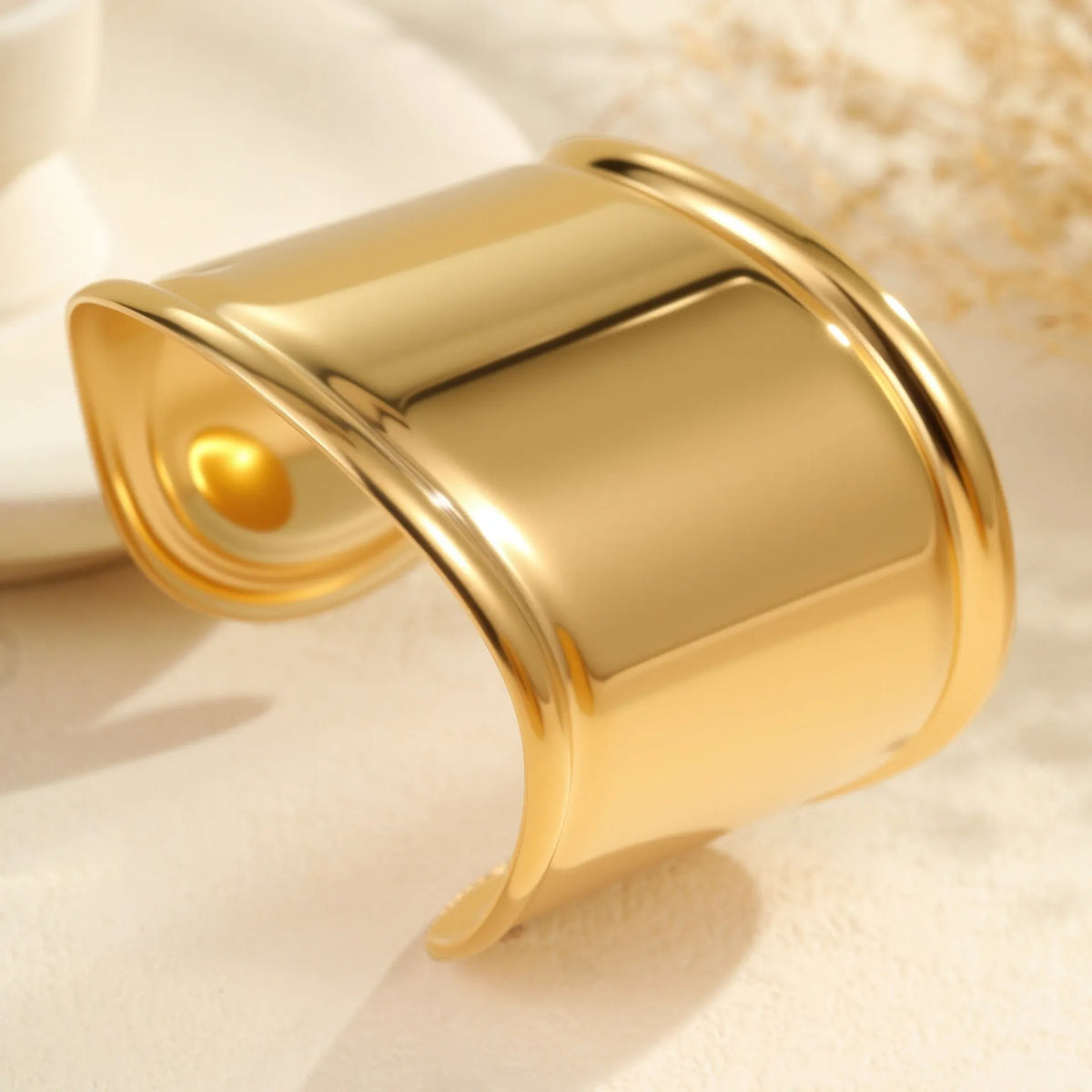 Women's fashion bracelet with exaggerated wide design and geometric wave pattern in gold plating