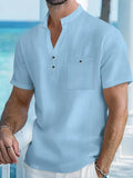 Men's light blue linen short sleeve shirt with a stand collar in a loose pullover fit.