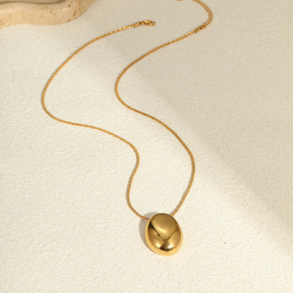 Gold-plated geometric pendant necklace with adjustable chain on model