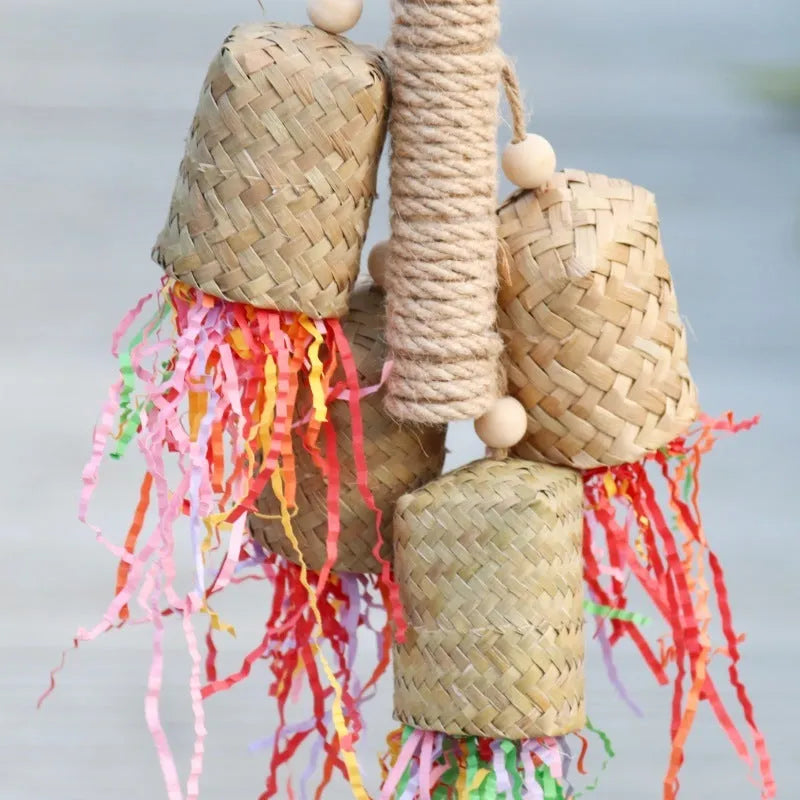 Colourful shredded paper parrot toy on wooden perch with sisal rope attachments