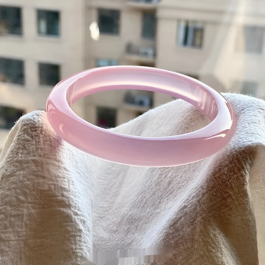Natural agate wide tyre bracelet in pink colour, showing smooth bead design and internal diameter size.